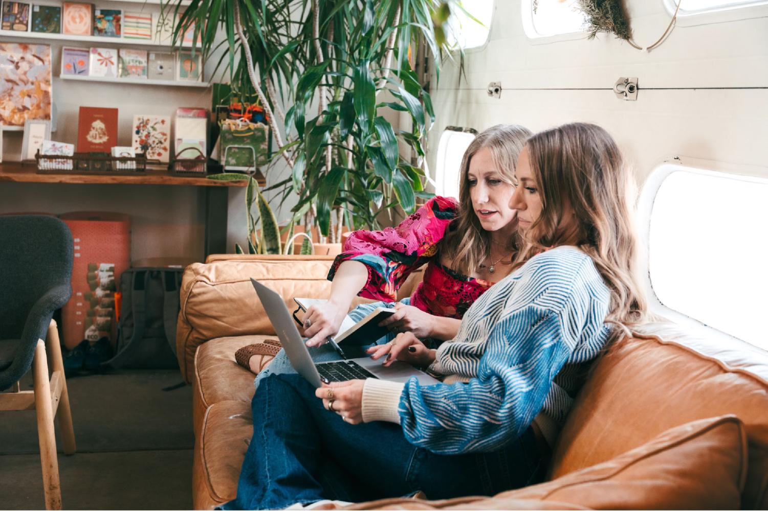 Two women looking at a laptop